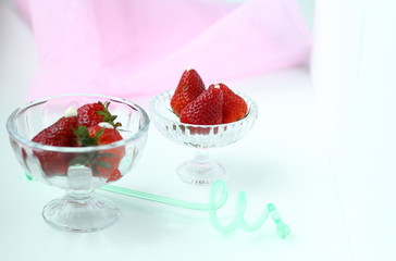 Fresh strawberry pieces in a rustic glass