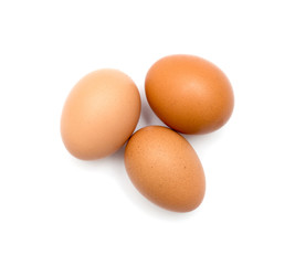 Three brown eggs on white background