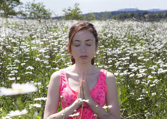 Young woman meditating in nature