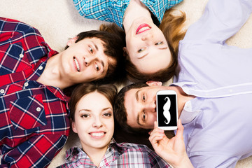 four young men lie together