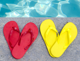 Fototapeta na wymiar Color flip flops by the pool