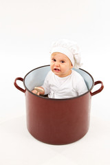 baby sitting inside a pot