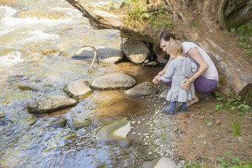 mother with her toddler baby in the nature