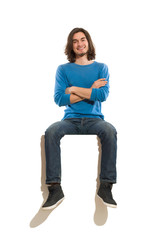Handsome man sitting on top of something