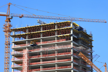 Crane and high-rise building under construction.