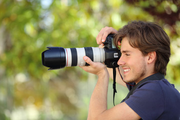 Fototapeta na wymiar Photographer taking a photograph outdoor with a dslr camera