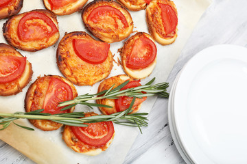 Small pizzas on baking paper close up