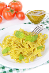 Fototapeta na wymiar Delicious pasta with pesto on plate on table close-up