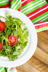 Green salad made with  arugula, tomatoes and sesame