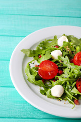 Green salad made with  arugula, tomatoes, cheese mozzarella
