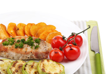 Grilled steak and grilled vegetables on plate, isolated on
