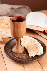 Cup of wine and bread on table close-up