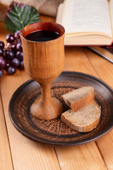 Cup of wine and bread on table close-up
