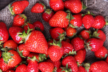 Ripe sweet strawberries on sackcloth  background