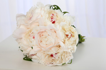 Beautiful wedding bouquet on table on light background