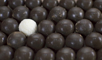 Round chocolate candies with one white candy