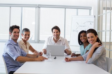 Attractive business people smiling at the camera