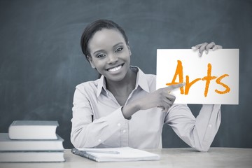 Happy teacher holding page showing arts