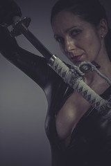 brunette woman wearing black latex, Japanese katana