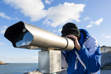 Man looking forward by telescope