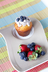 Muffin, strawberries and blueberries
