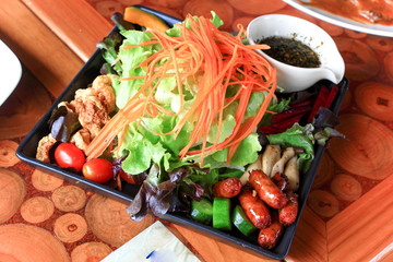 Vegetable salad with Thai Northern sausage in resturant.