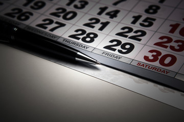 wall calendar with pen closeup