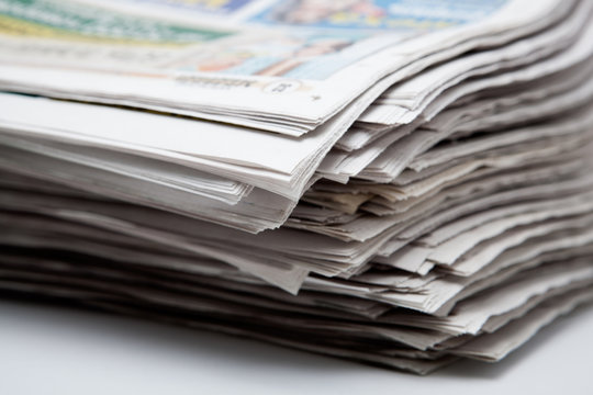 stack of newspapers on a white background