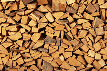 A stack of spruce firewood - a natural horizontal background..