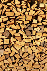 Background of dry chopped firewood logs in a pile