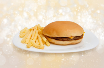 Cheeseburger on dinner plate with french fries isolated