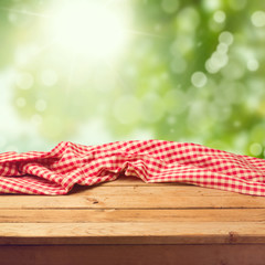 Empty wooden deck table with tablecloth