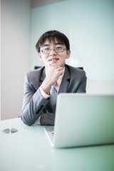 Young handsome man using laptop in his office