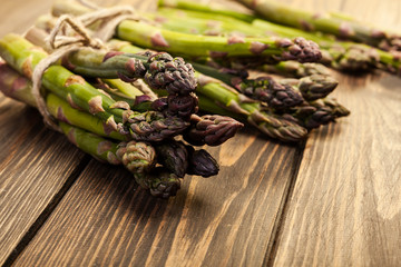 Bunch of young asparagus on wooden table