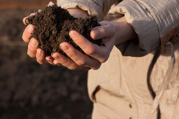 hands with soil