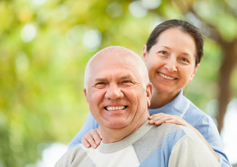 Fototapeta premium Happy mature couple together in autumn park