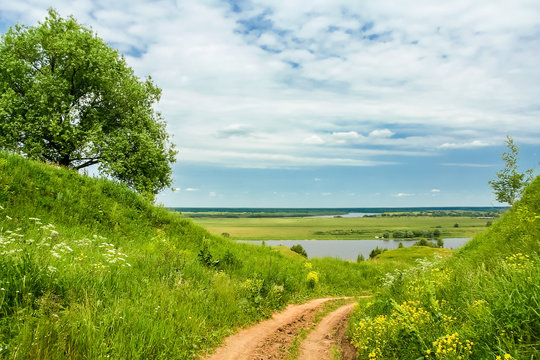 Road In The Green Hills To The River Bank