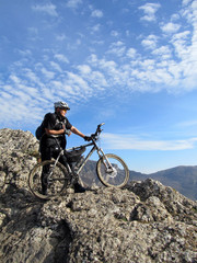 Fototapeta premium Cyclist Riding the Bike on the Beautiful Spring Mountain Trail