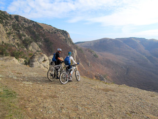 Fototapeta premium Cyclist Riding the Bike on the Beautiful Spring Mountain Trail