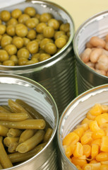 Open tin cans of peas, corn, bean and french bean close-up