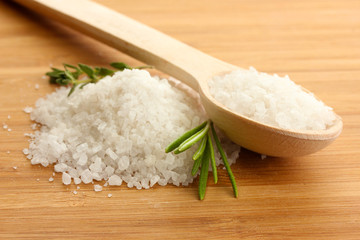 salt in spoon with fresh  rosemary and thyme