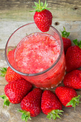 Fresh strawberry drink on wood background