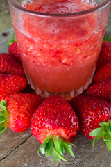 Fresh strawberry drink on wood background