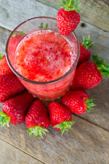 Fresh strawberry drink on wood background