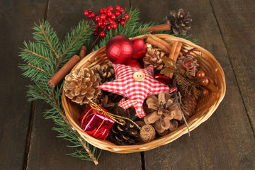 Christmas decorations in basket and spruce branches
