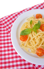 Delicious spaghetti with tomatoes on plate on table close-up