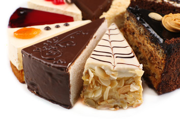 Assortment of pieces of cake, isolated on white © Africa Studio