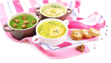 Tasty soup in saucepans, isolated on white