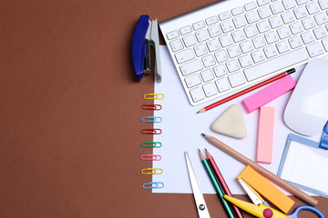 Office table with stationery accessories, keyboard and paper,