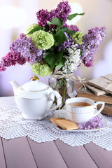 Composition with teapot,  mug and beautiful spring flowers in